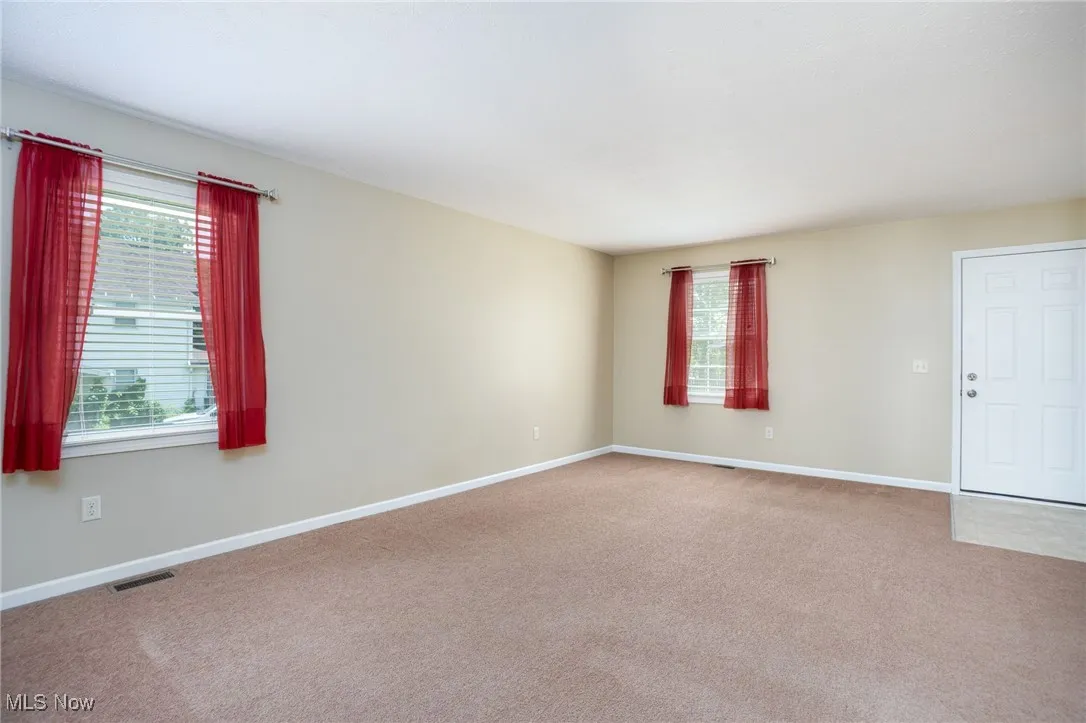 Spare room featuring carpet and healthy amount of natural light
