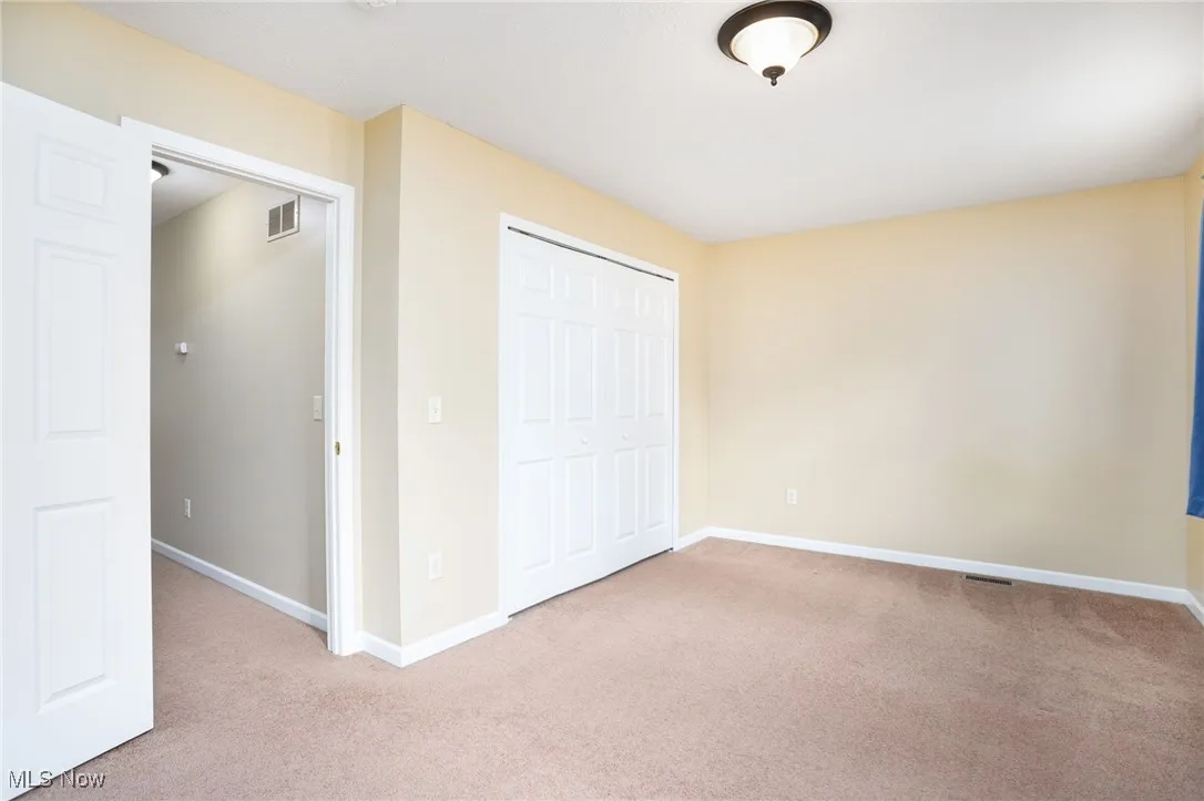 Unfurnished bedroom featuring carpet and a closet