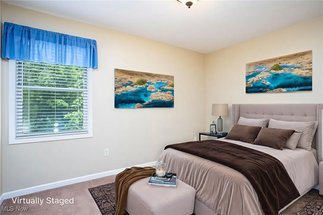 Carpeted bedroom with multiple windows