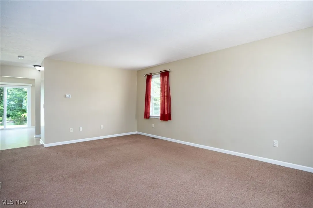 Unfurnished room with carpet floors and baseboards