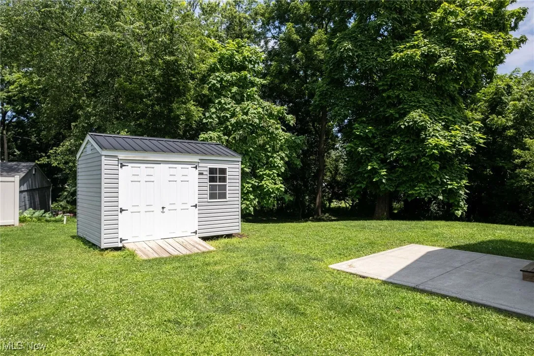 View of green lawn with a storage unit