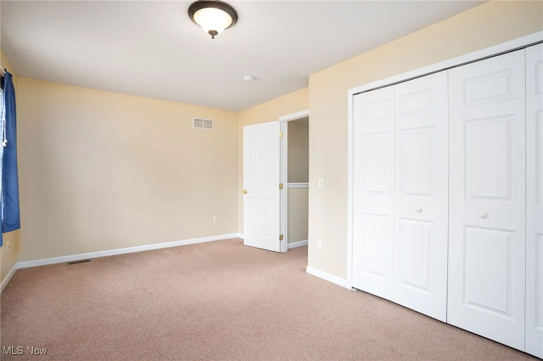 Unfurnished bedroom featuring carpet floors and a closet