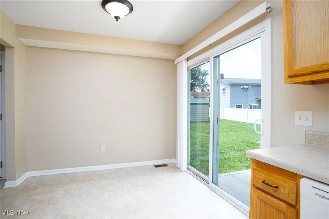 Unfurnished dining area featuring baseboards and light flooring