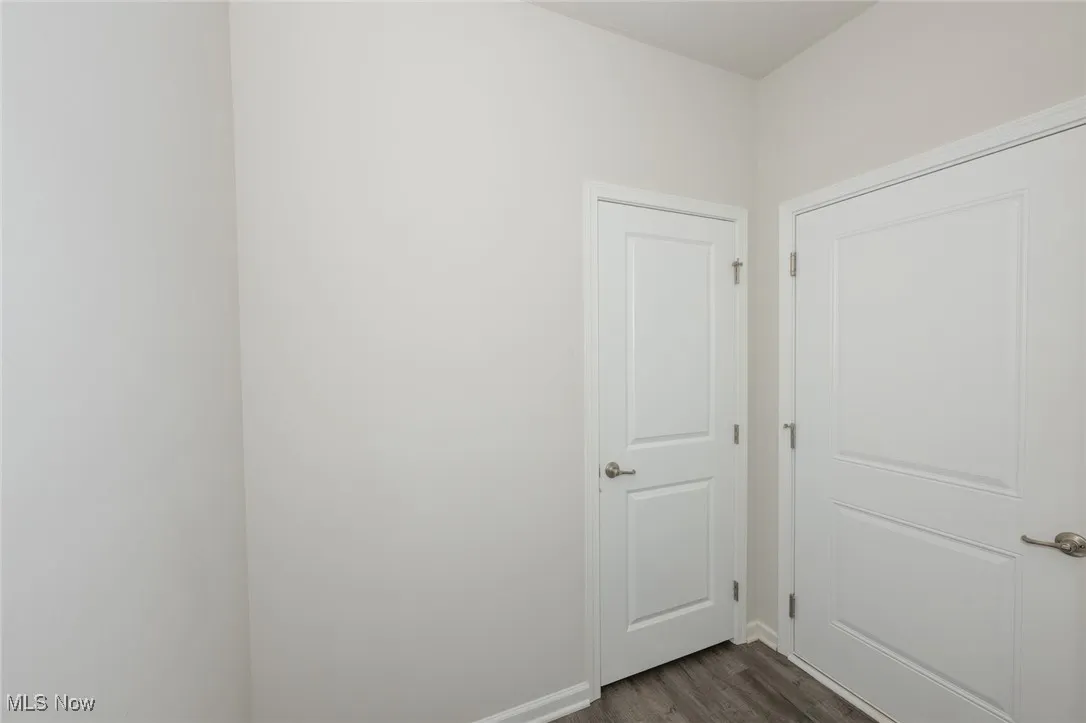 Spare room with dark wood-type flooring