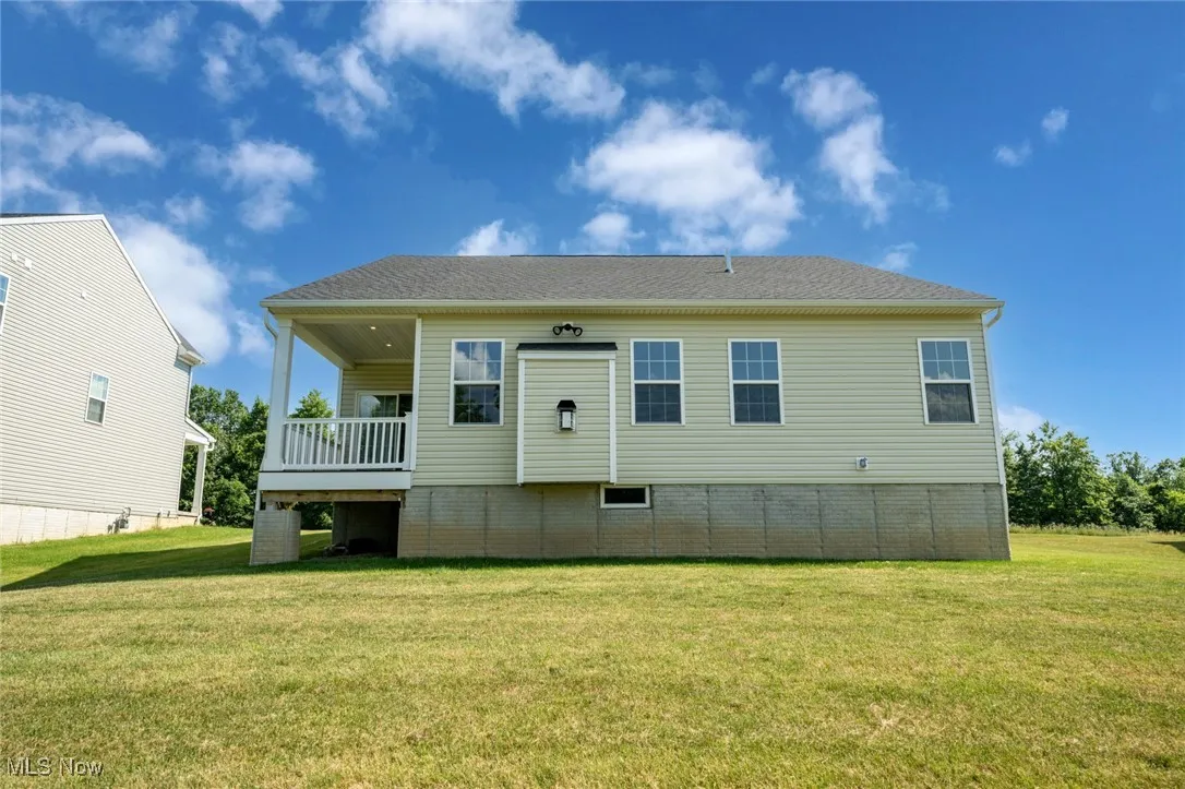 Rear view of property featuring a yard