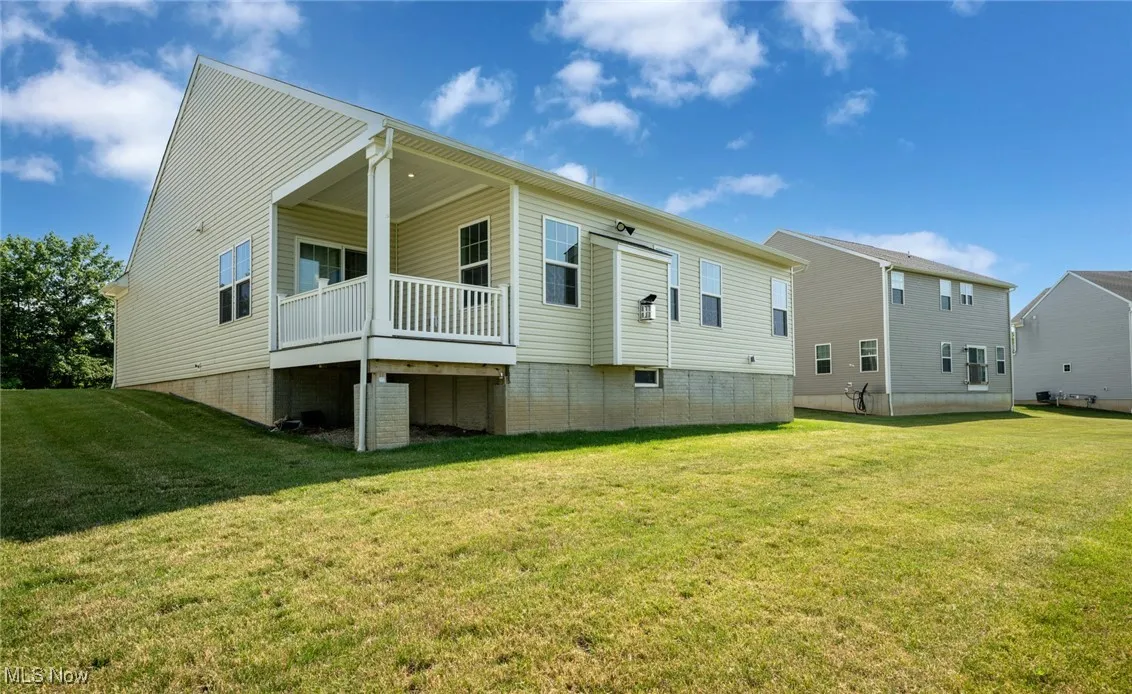 Back of property featuring a yard