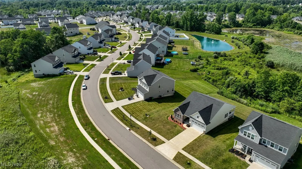 Aerial view of residential area featuring a nearby body of water