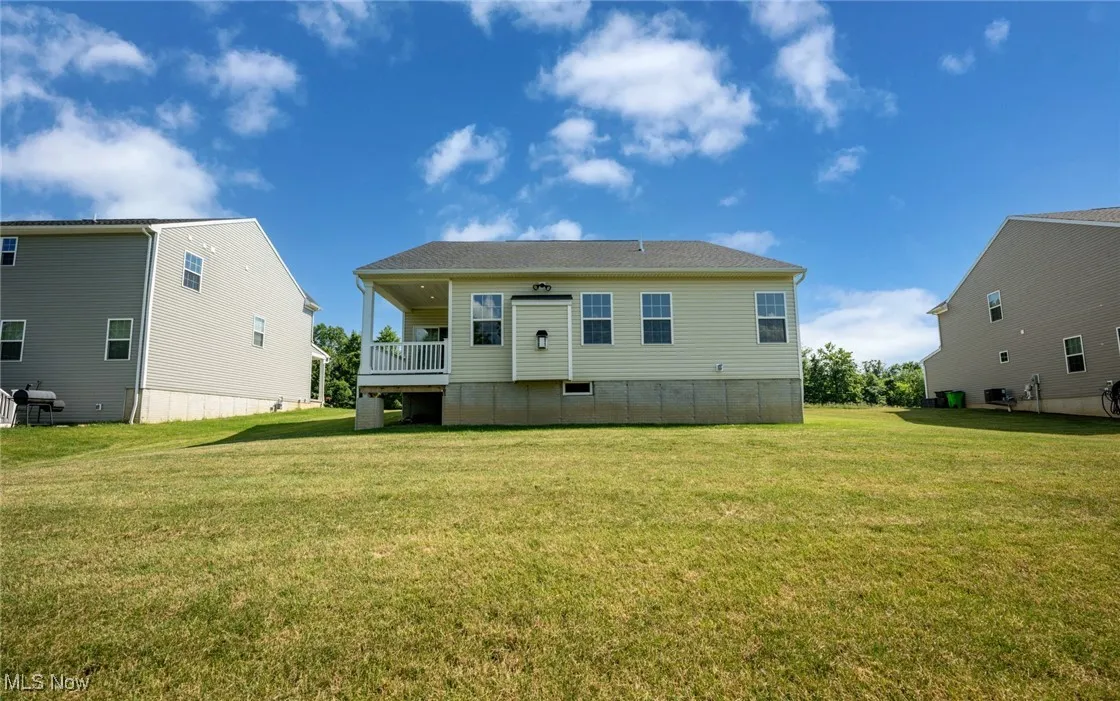 Rear view of house with a yard