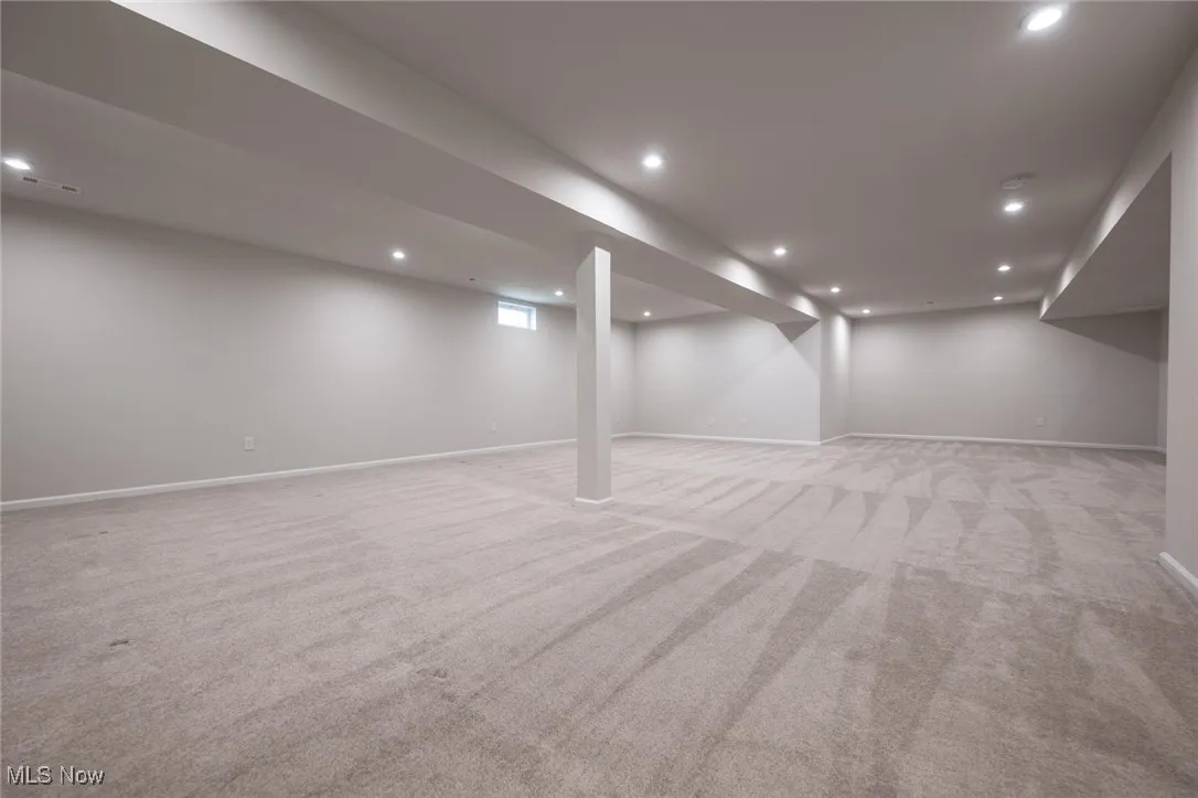 Finished basement featuring recessed lighting and light colored carpet
