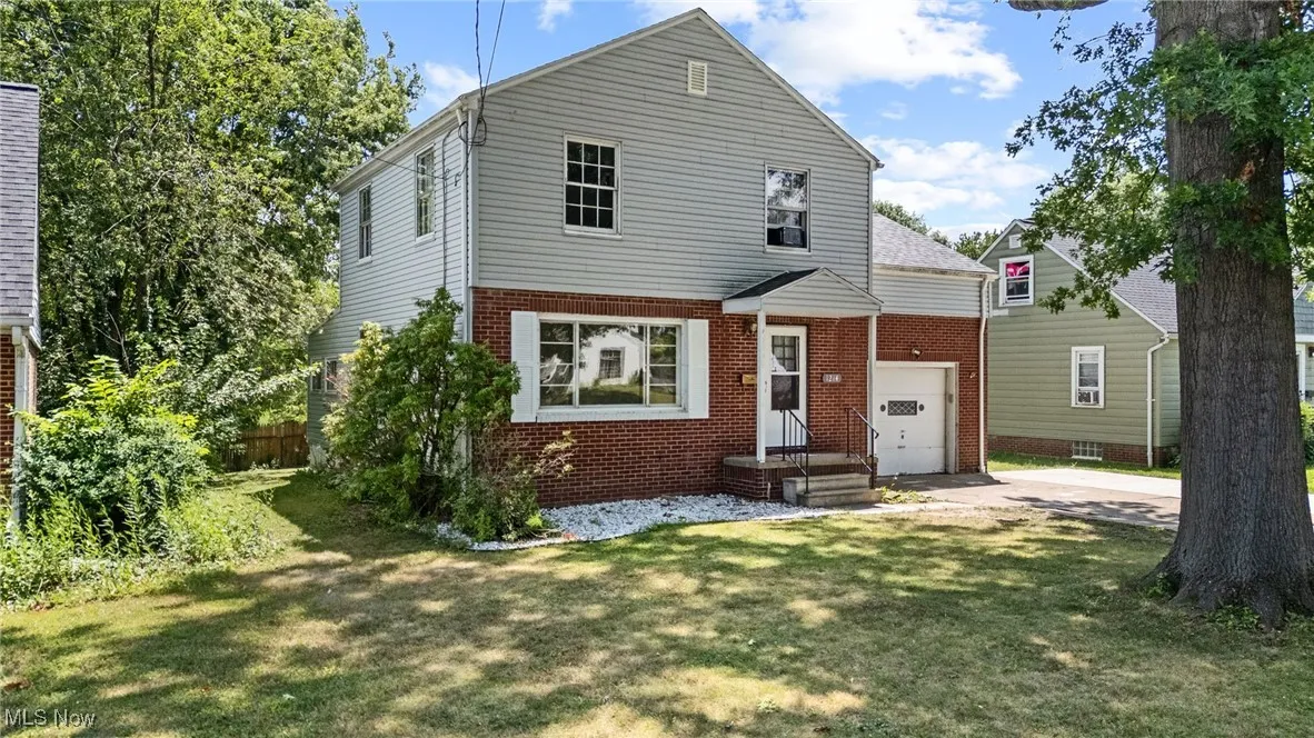 View of front of house featuring brick siding, a garage, and concrete driveway
