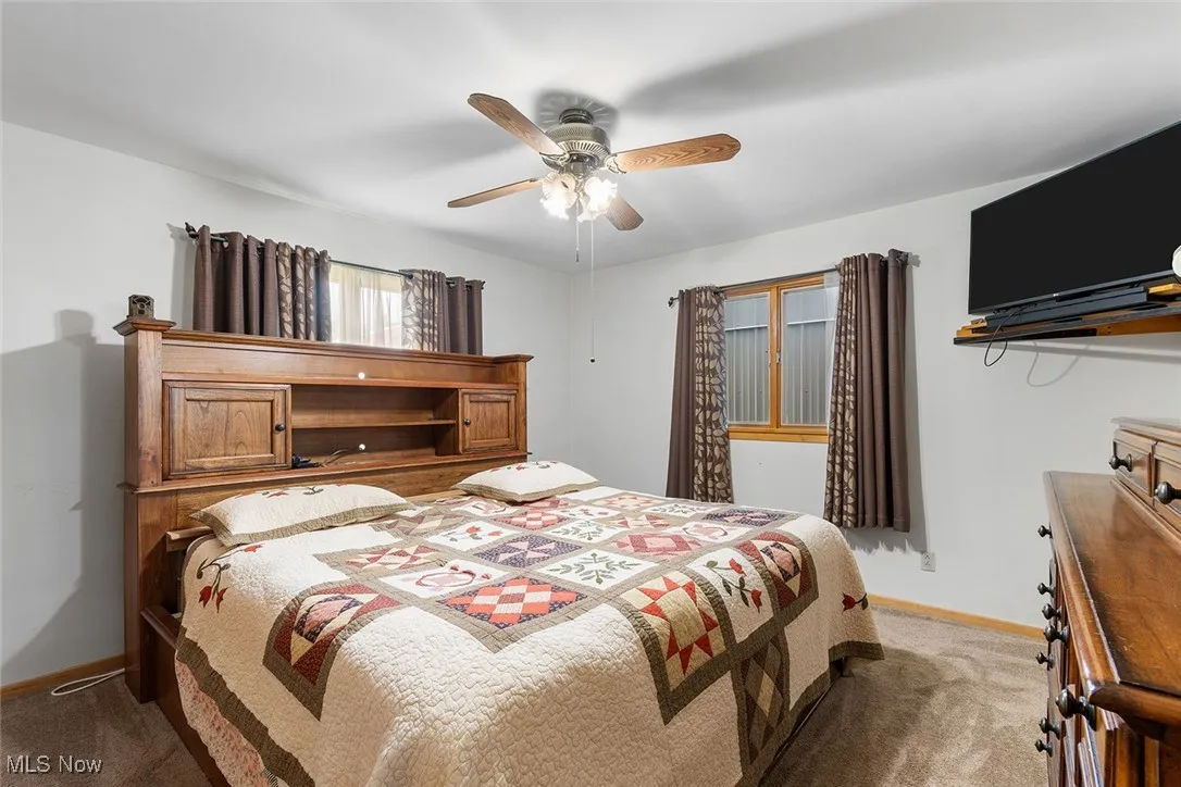 Bedroom featuring light colored carpet and ceiling fan