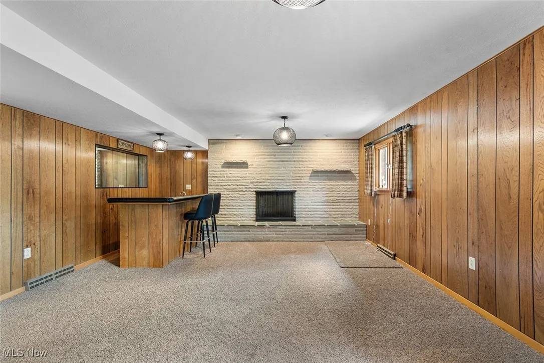 Family room in basement with fireplace