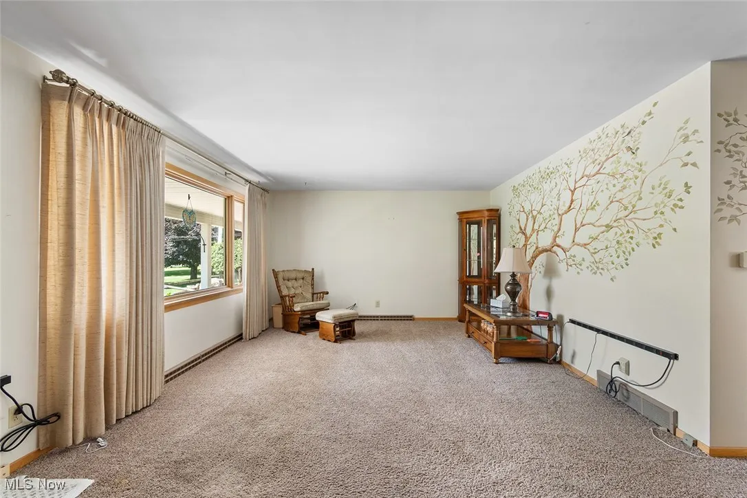 Living room with carpet and baseboards