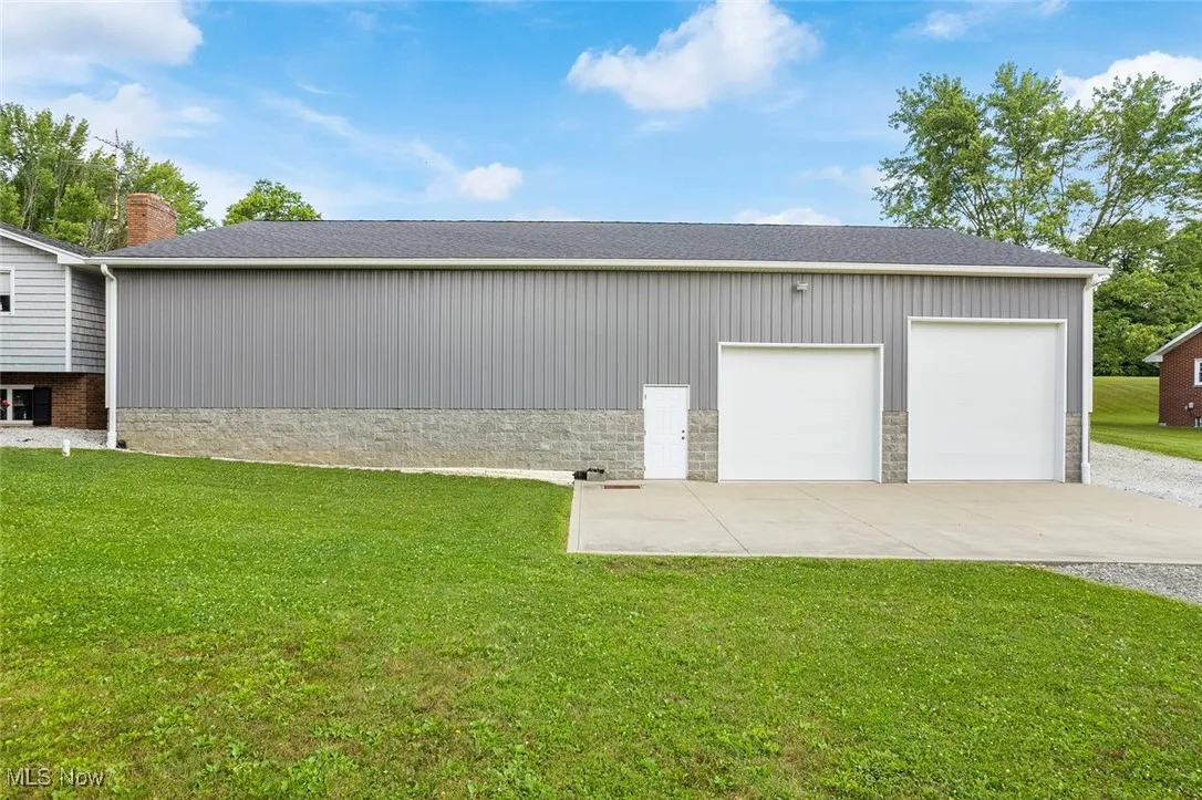 Garage featuring concrete driveway