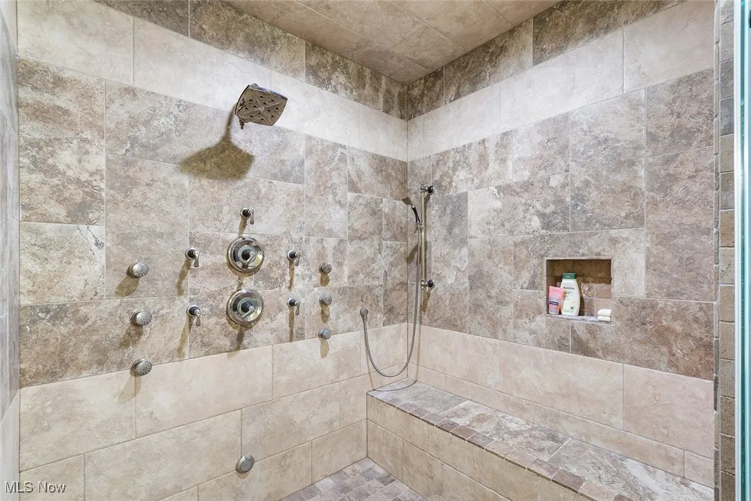 Full bathroom featuring tiled shower