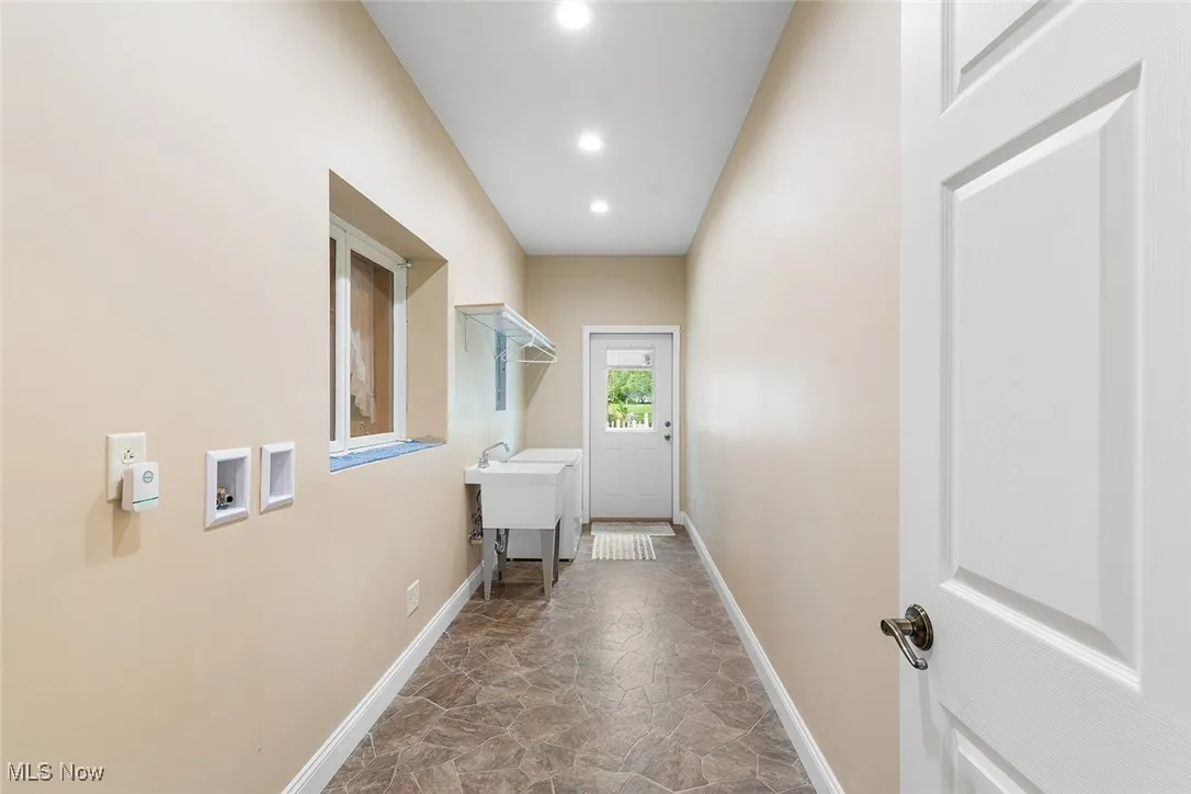 Laundry area with recessed lighting and stone finish flooring