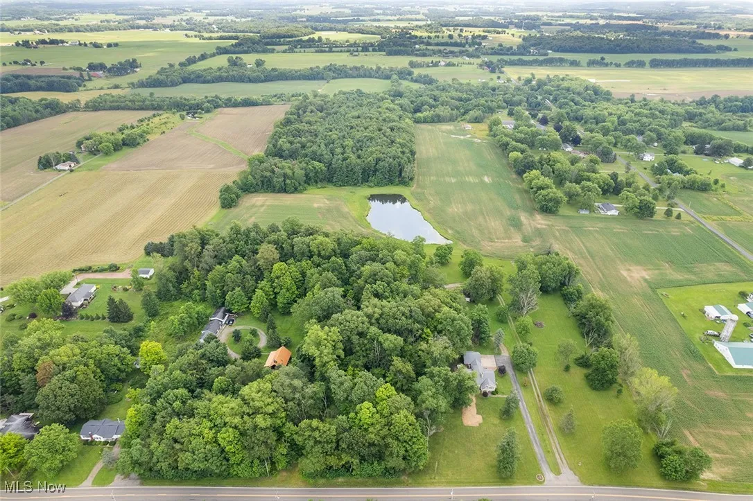 Aerial view of property's location featuring rural landscape and a large body of water