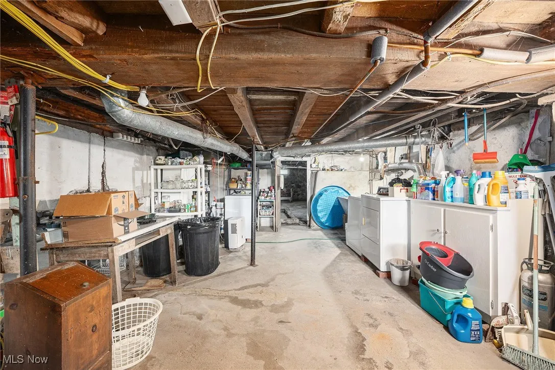 Unfinished basement featuring washer and clothes dryer