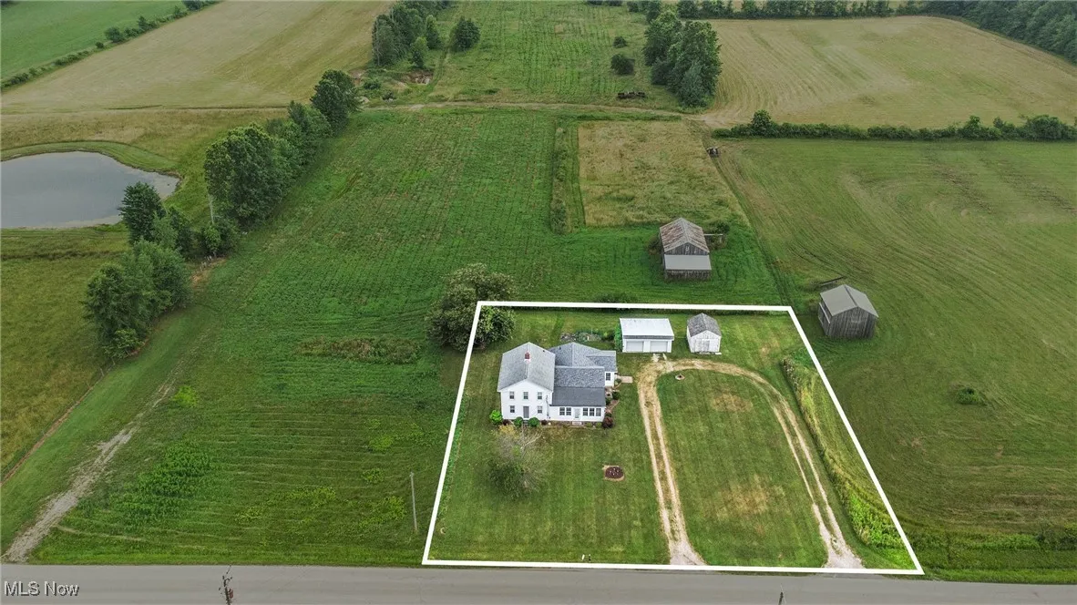 Aerial view of sparsely populated area with property boundaries highlighted and a large body of water