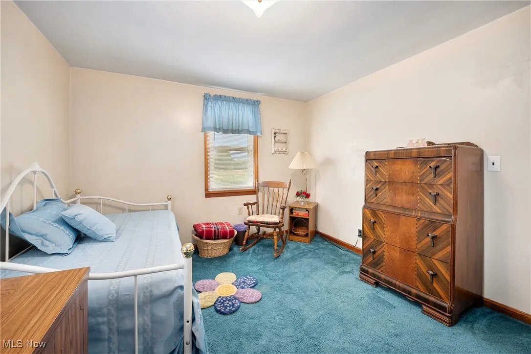 Bedroom with carpet floors and baseboards