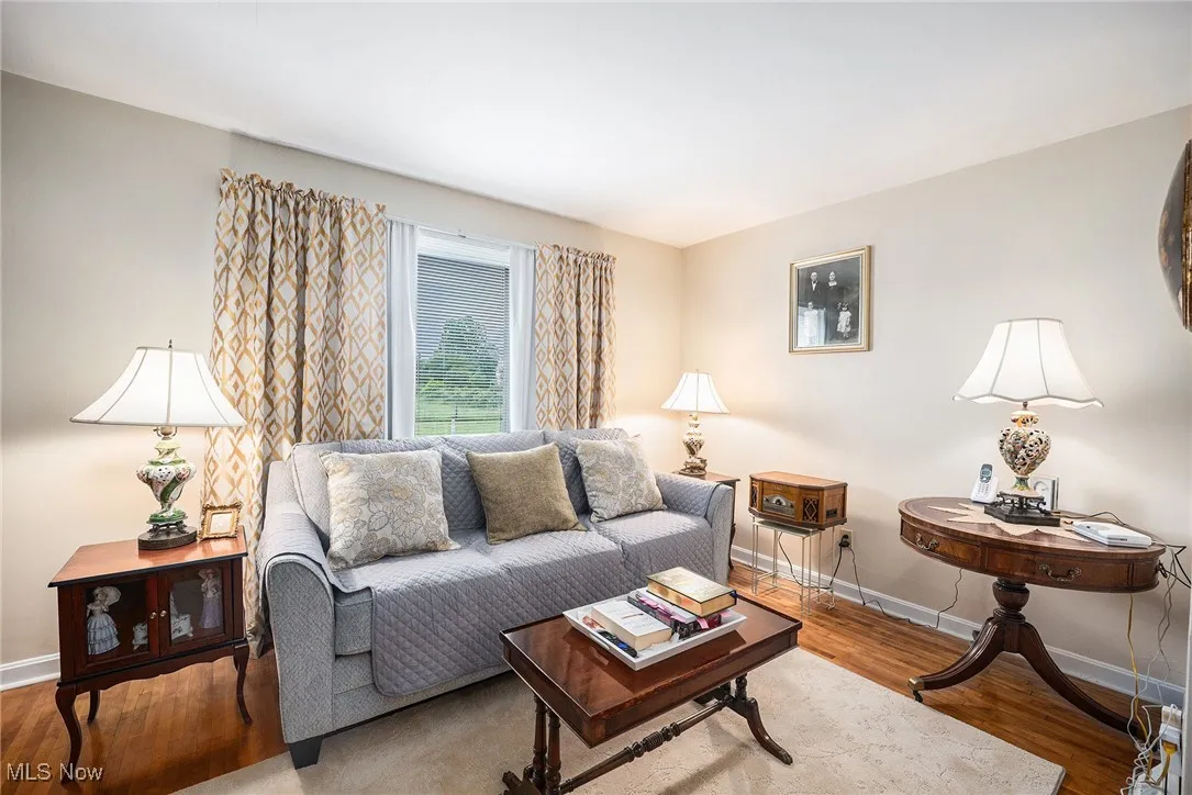 Living area featuring baseboards and wood finished floors