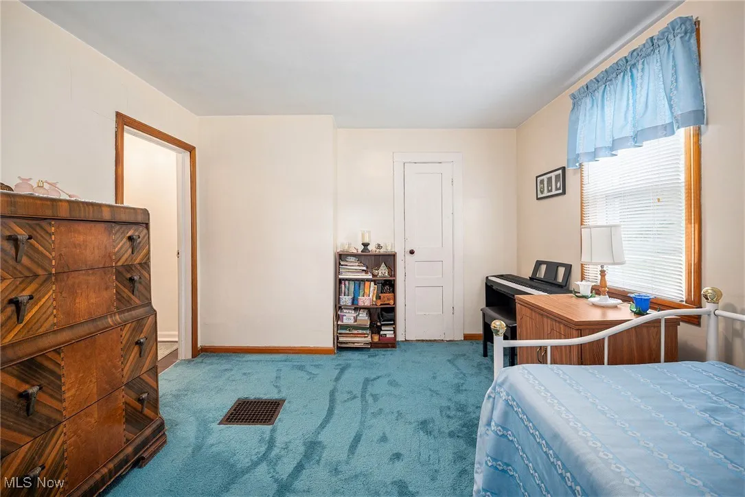 Bedroom with carpet and baseboards