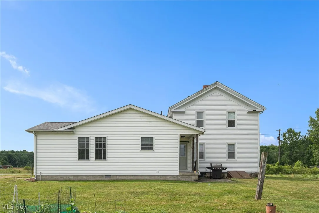Back of house featuring a yard