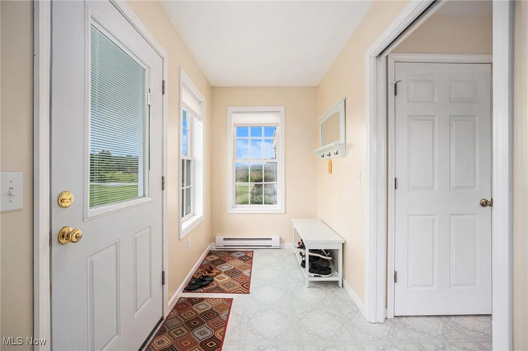 Entryway featuring baseboard heating and healthy amount of natural light
