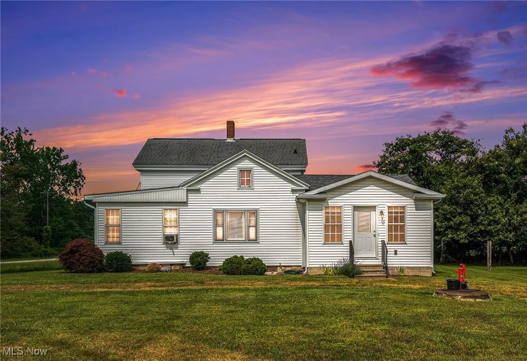 Traditional home with a front lawn and a chimney