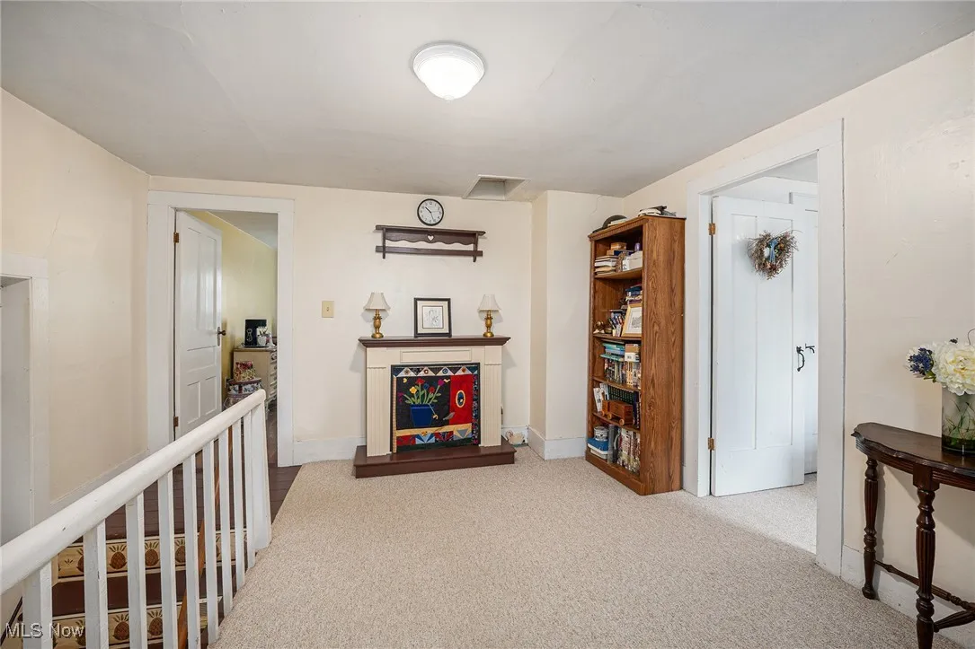 Hall featuring carpet and baseboards