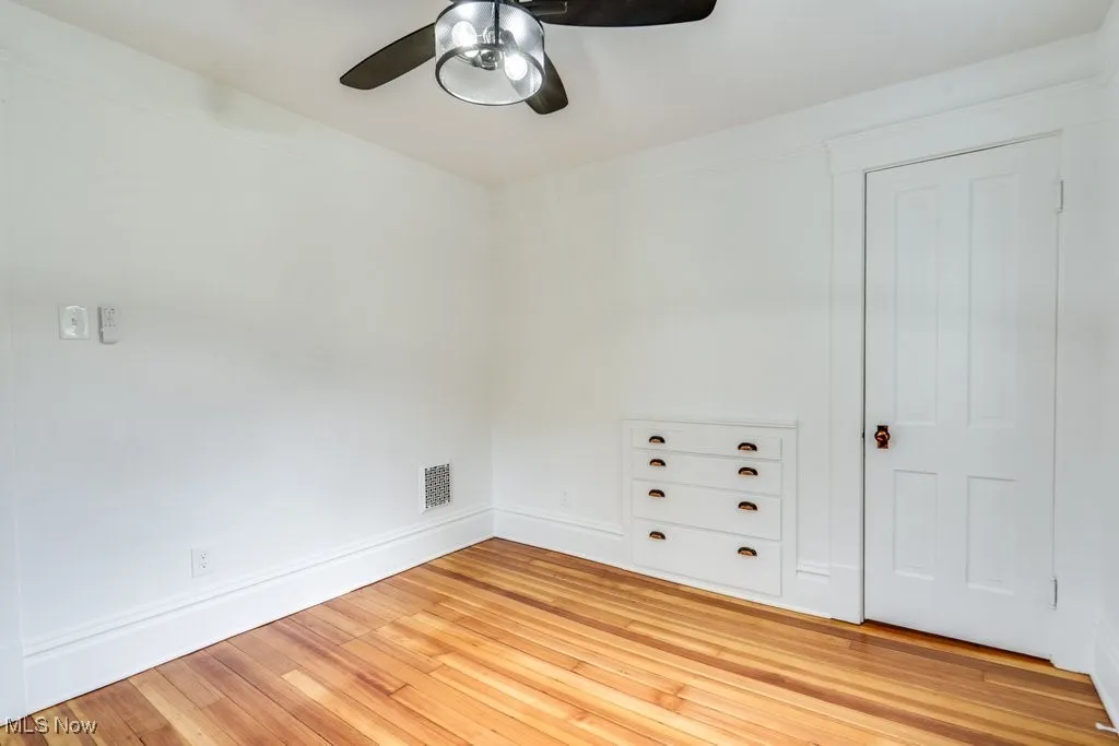 Spare room with ceiling fan and light wood-style floors