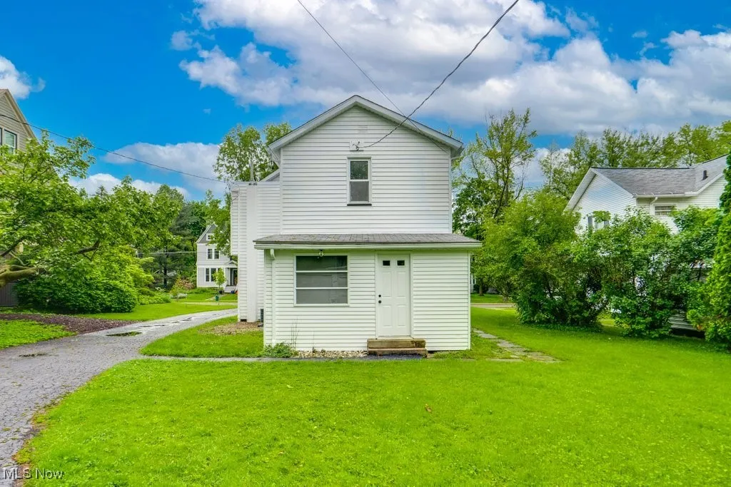 Back of house with a lawn