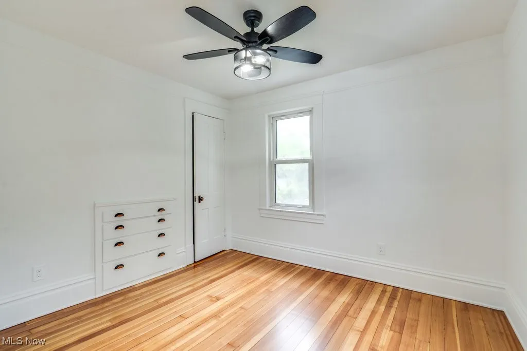 Spare room with light wood-type flooring and ceiling fan