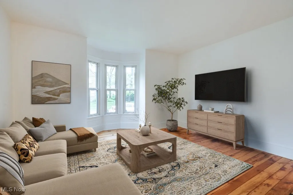 Living room featuring light wood-style flooring and baseboards