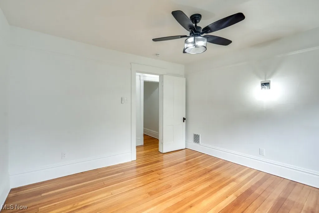 Unfurnished room featuring light wood-style floors and a ceiling fan