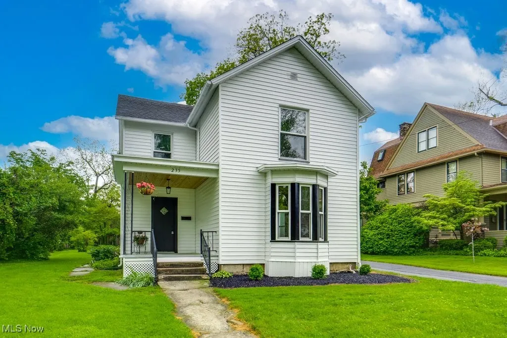 View of front of home featuring a front yard and a porch