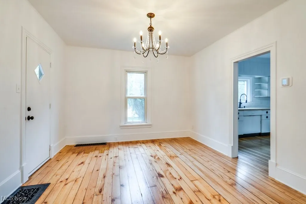 Foyer entrance featuring a chandelier and light wood-type flooring