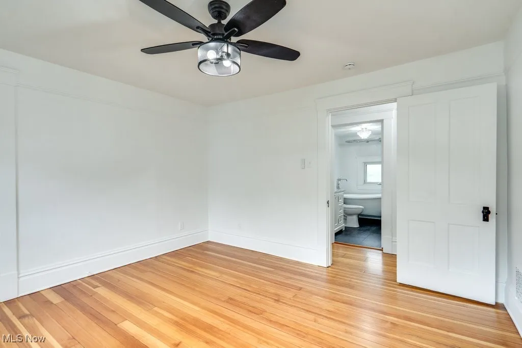 Spare room with a ceiling fan, light wood-style floors, and a smoke detector