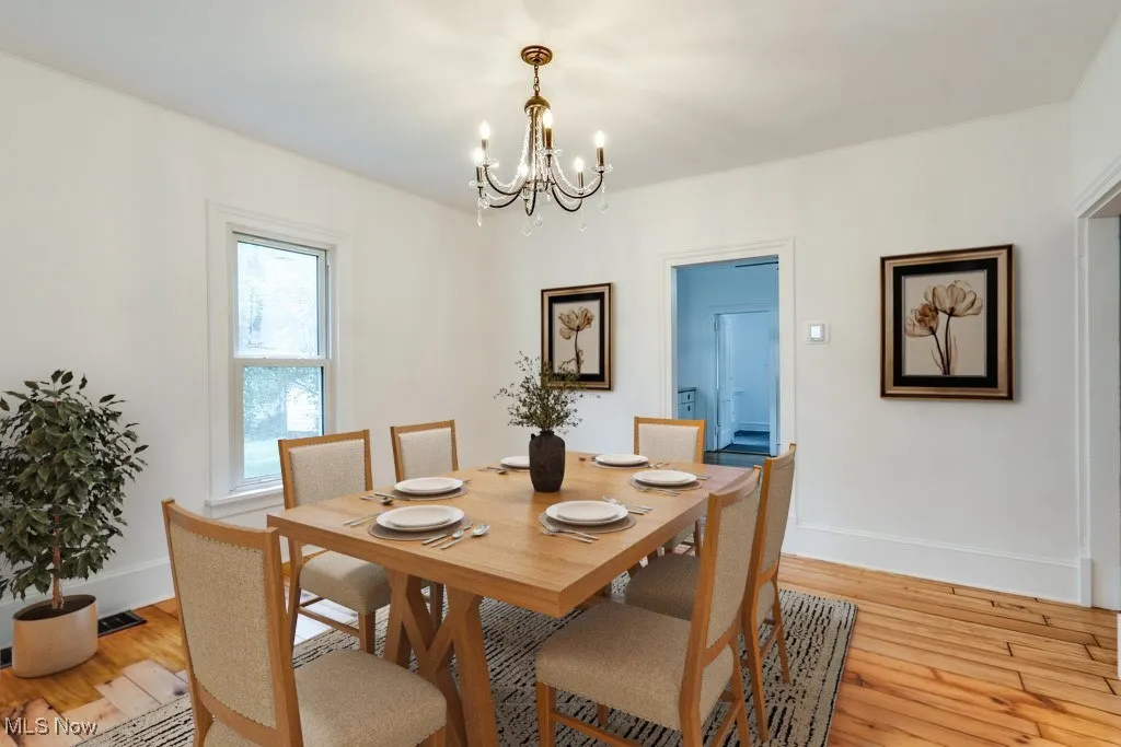Dining space featuring a chandelier and light wood-type flooring