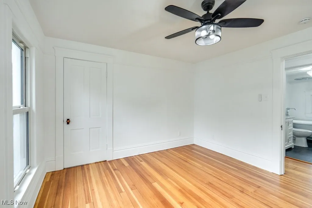 Spare room with a ceiling fan and light wood finished floors