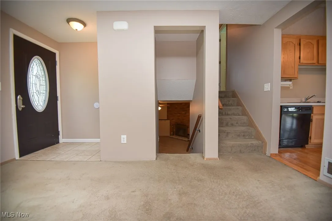 Stairs to the upper level with bedrooms and bathroom or to the lower level family room.