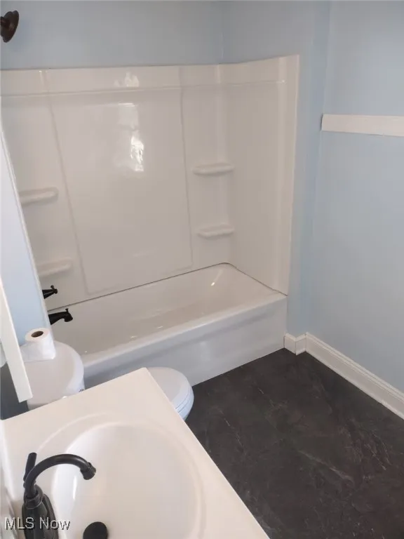 Full bath featuring toilet and bathing tub / shower combination