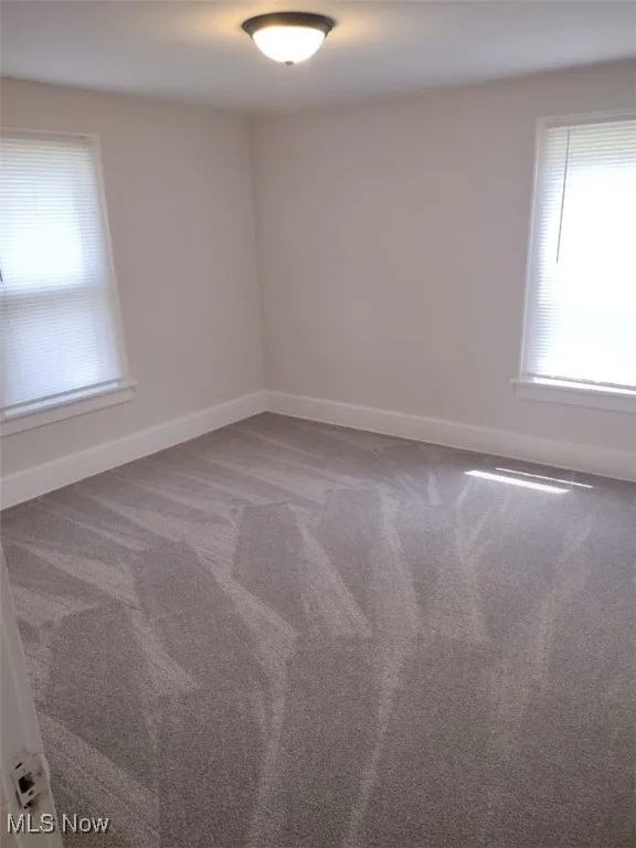Spare room featuring carpet