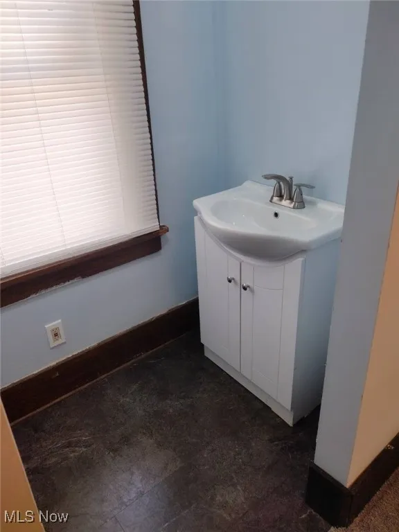 Bathroom featuring vanity and baseboards