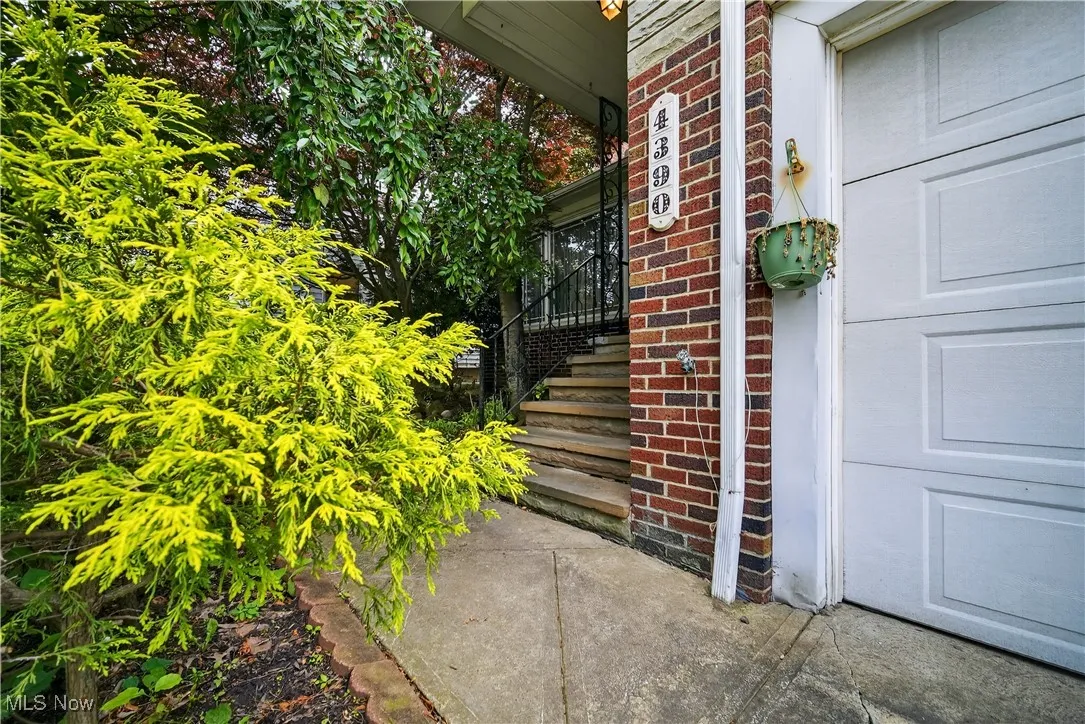 Doorway to property featuring brick siding