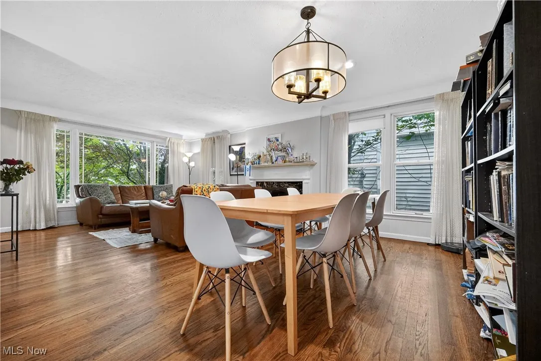 Dining space with wood finished floors and a chandelier
