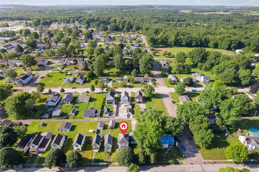 Aerial perspective of suburban area featuring a forest