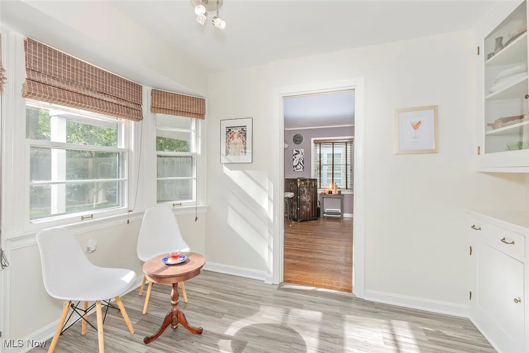 Eat-in kitchen with light wood-style flooring and baseboards