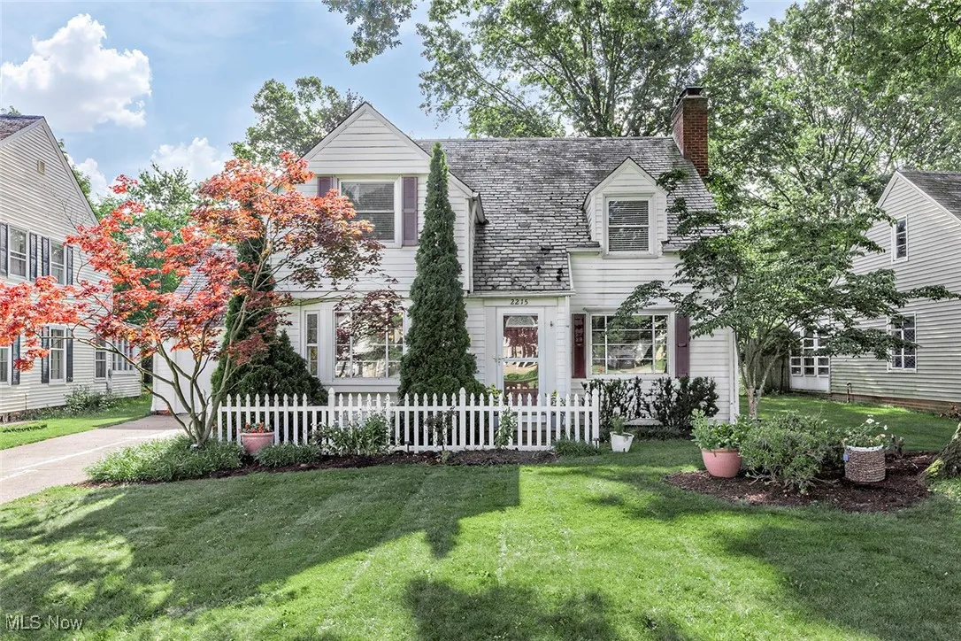 Cape cod-style house featuring a chimney
