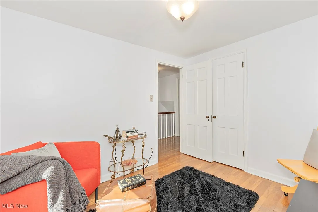Sitting room with wood finished floors and baseboards